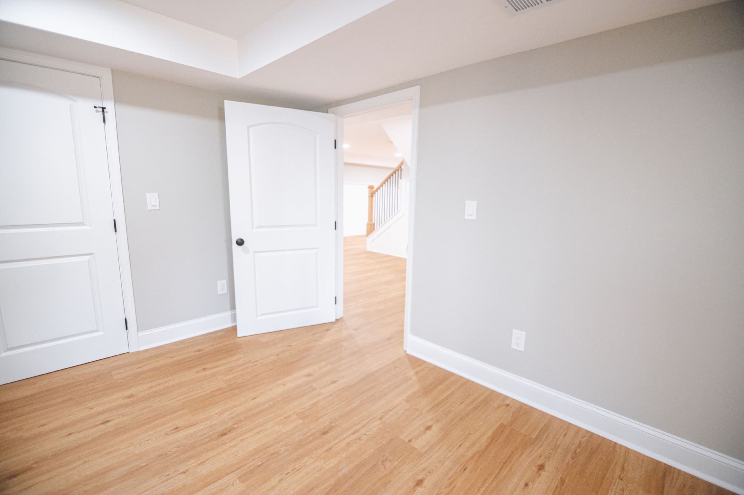 Ball Ground basement remodel — finished room with view to staircase