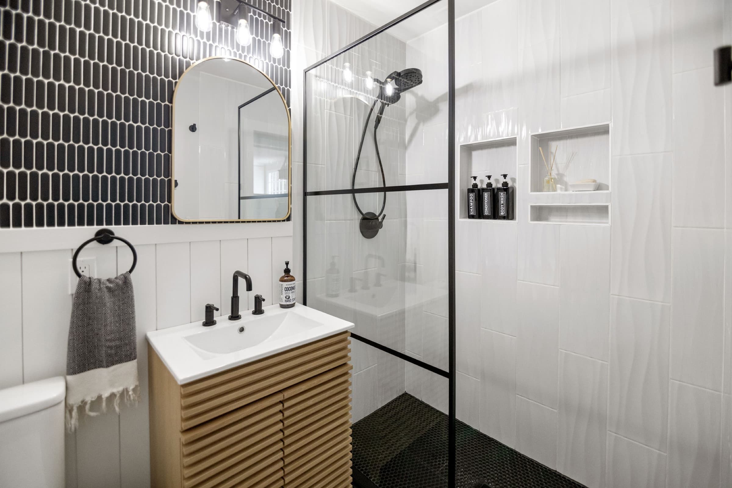 Candlestick Ct downstairs bathroom — vanity and shower wide view with patterned accent wall