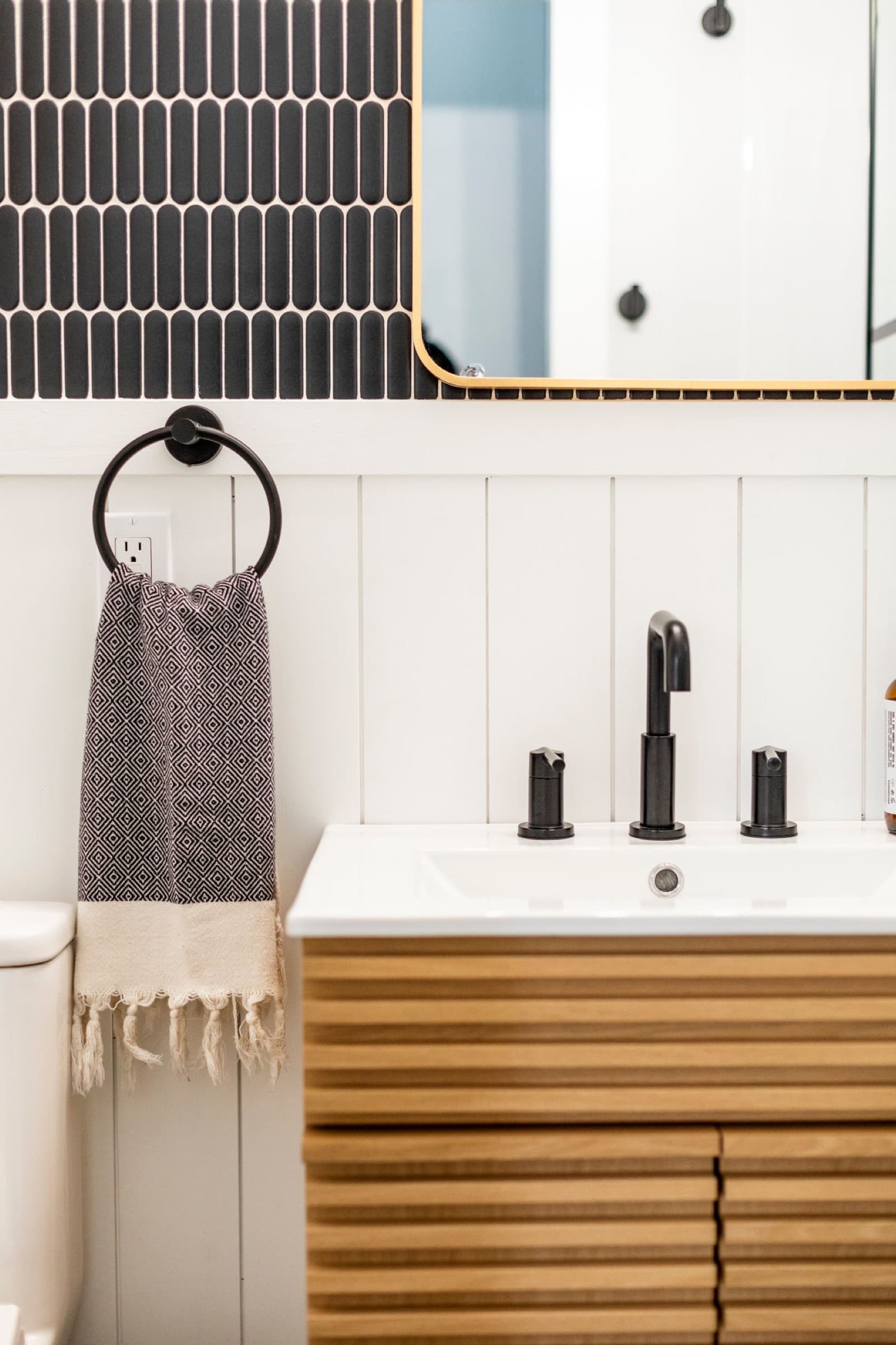 Candlestick Ct downstairs bathroom — vanity, mirror, and towel ring detail