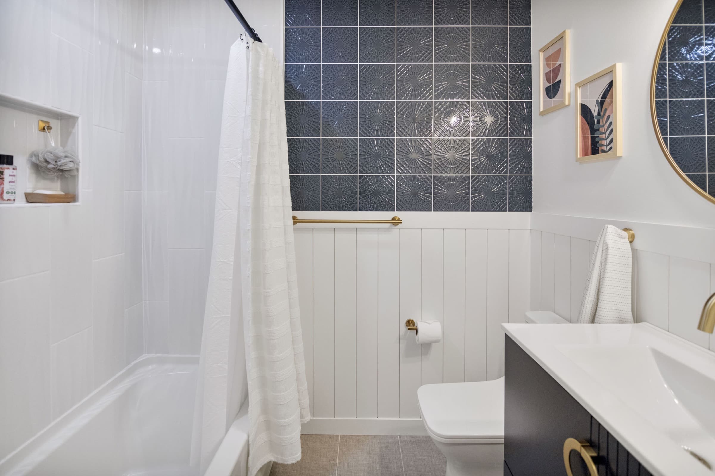 Candlestick Ct hall bathroom — tub-and-shower combo with patterned accent tile and gold towel bar