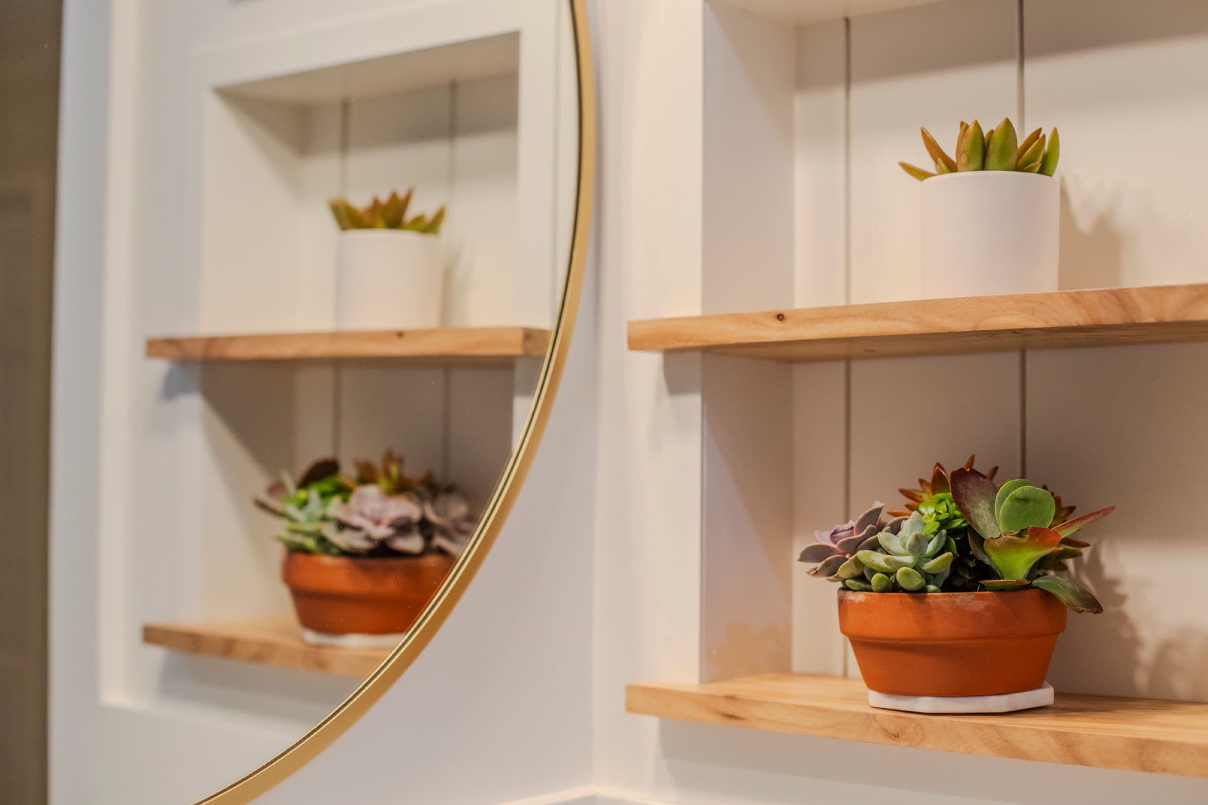 Candlestick Ct hall bathroom — floating wood shelf detail styled with succulents