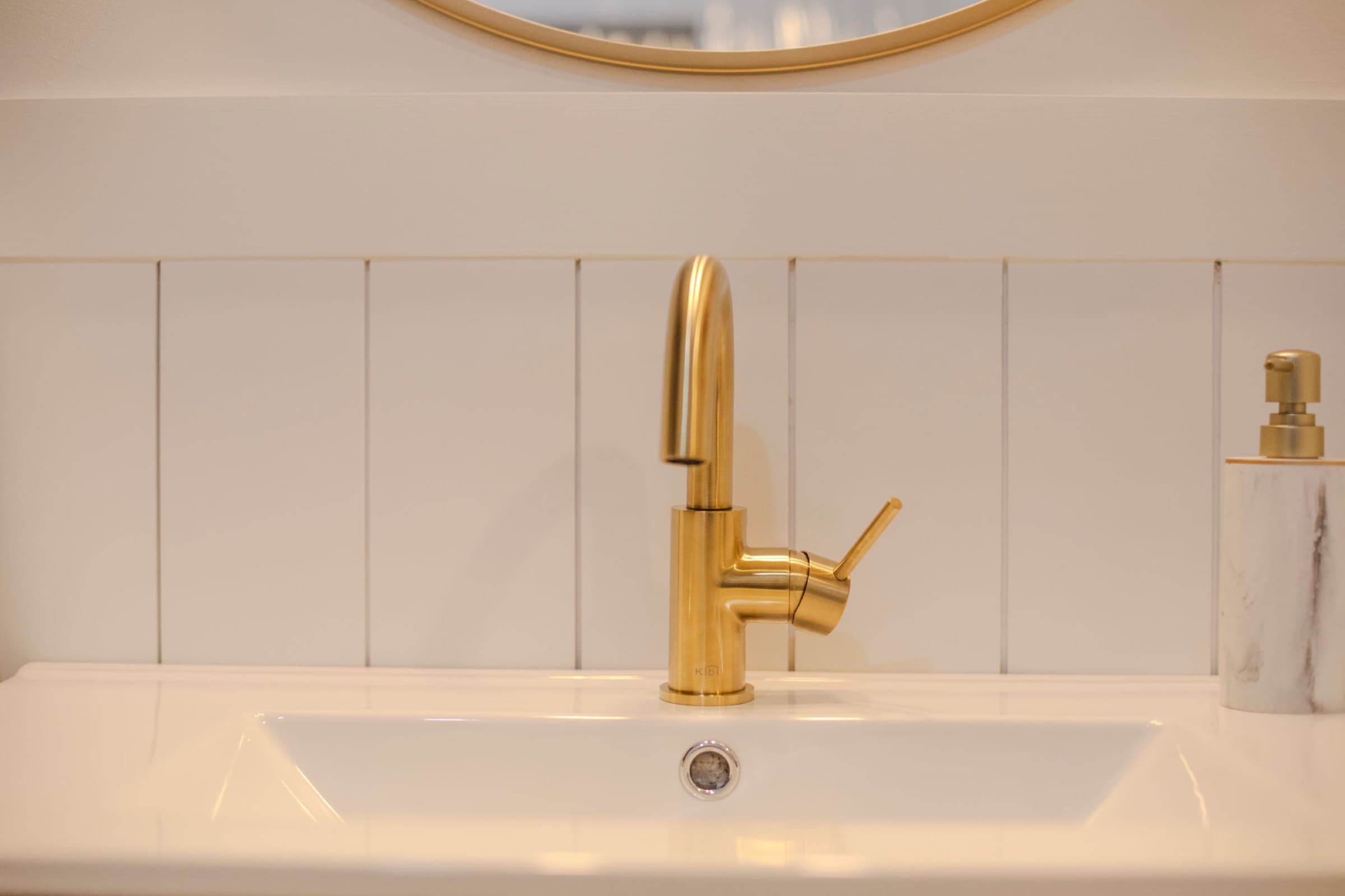 Candlestick Ct hall bathroom — brass gooseneck faucet detail