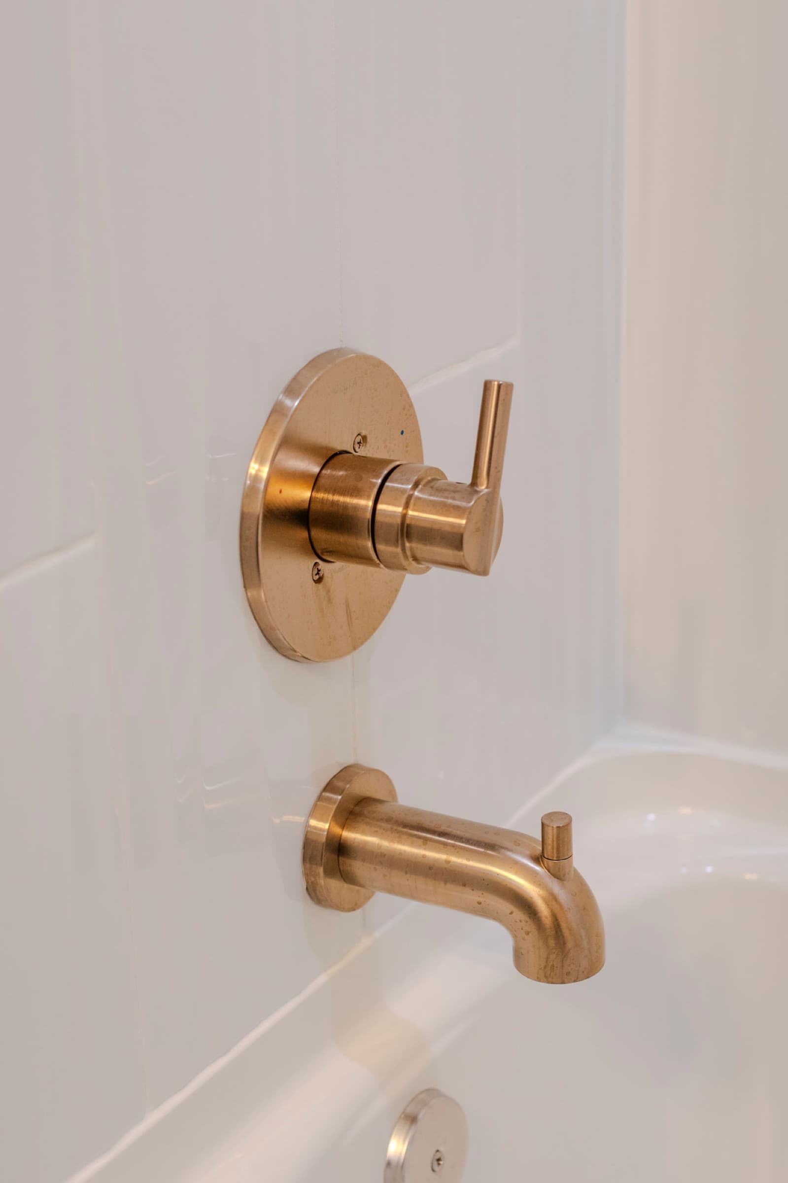 Candlestick Ct hall bathroom — brass tub spout and valve handle detail
