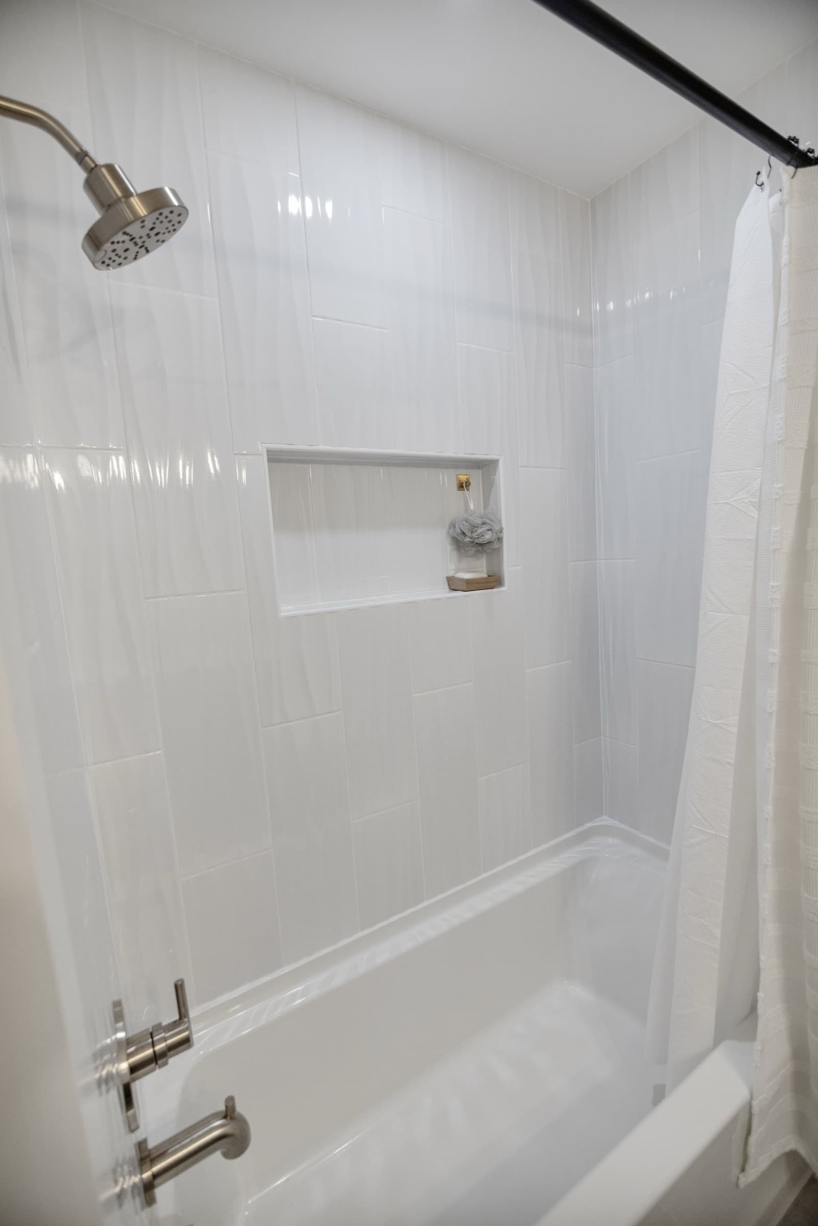 Candlestick Ct hall bathroom — tub-and-shower interior with tiled niche