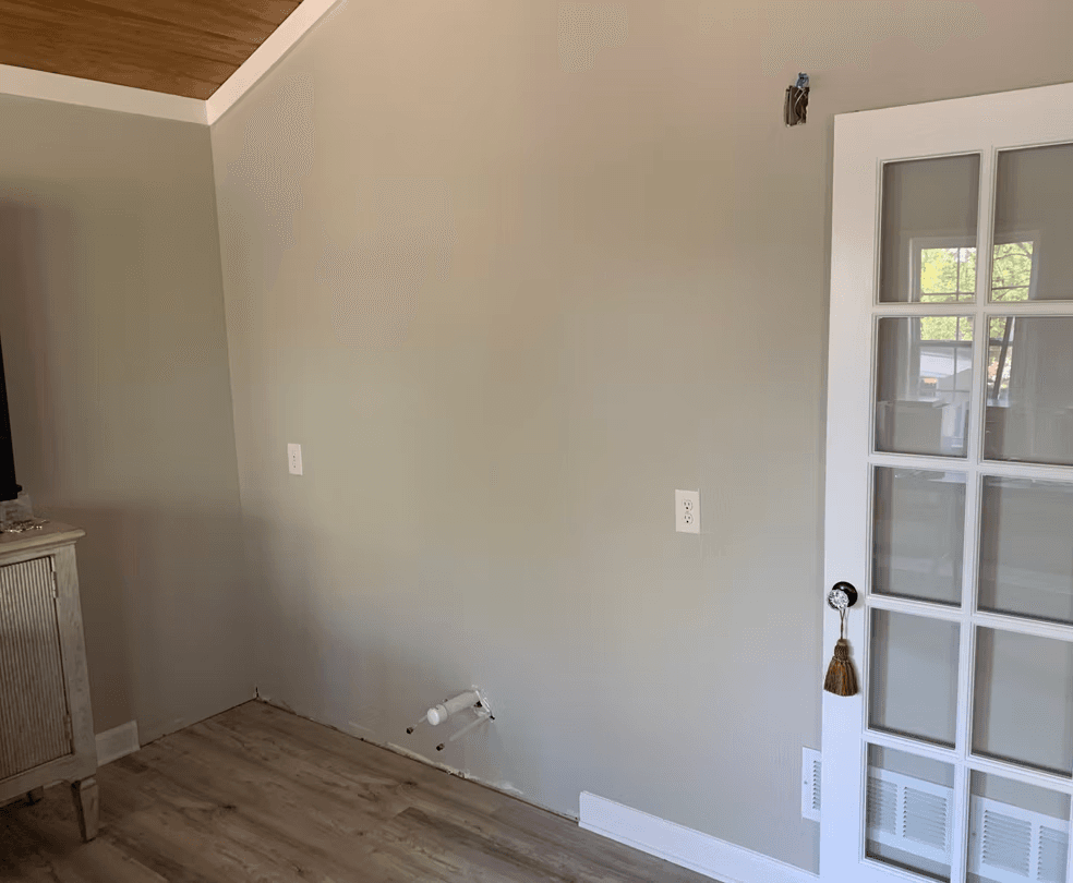 Custom wet bar — before, bare wall with plumbing and electrical rough-in