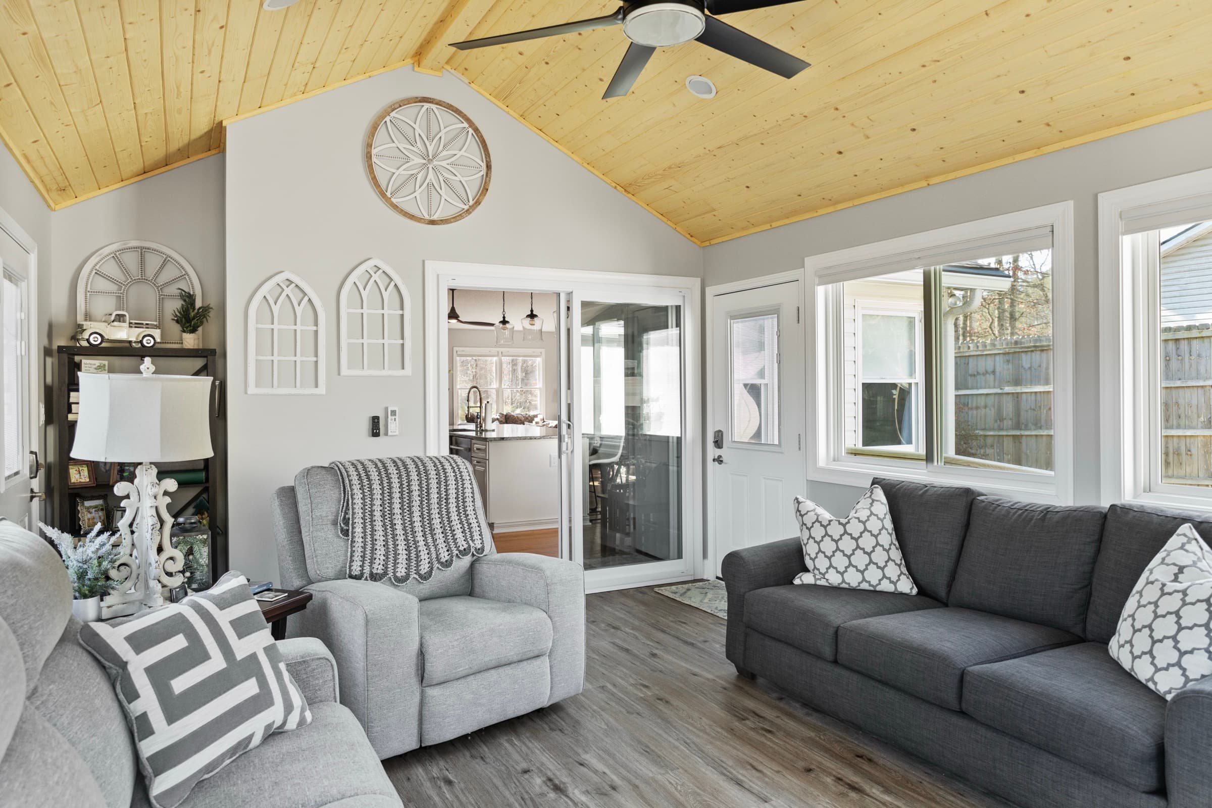 Galts Ferry sunroom addition — seating area with vaulted ceiling and sliding door to kitchen