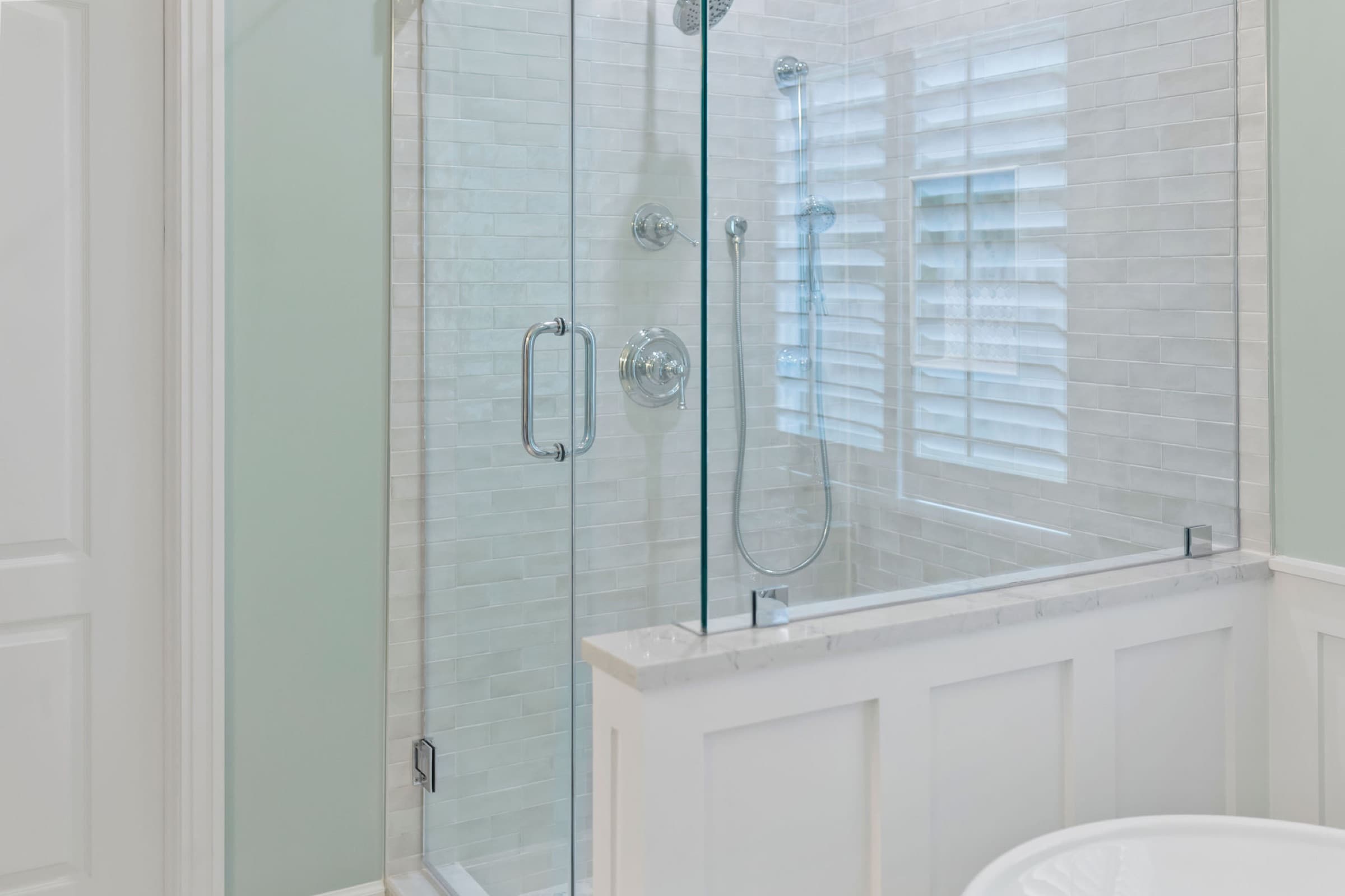 Spa-style bathroom remodel — frameless glass shower with subway tile