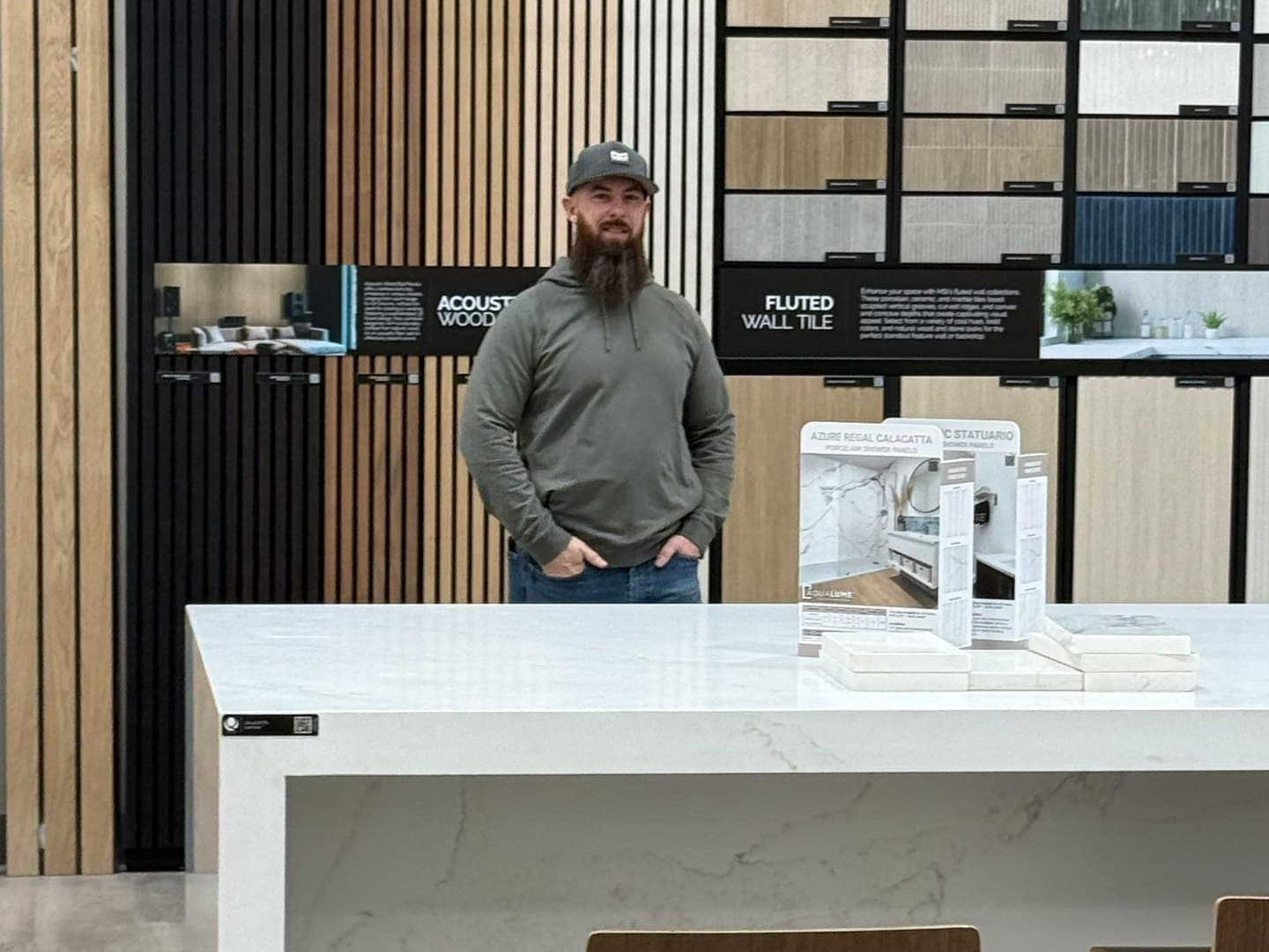 Joshua Ingram reviewing tile, wood, and countertop selections in a materials showroom
